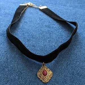 Elegant Black and Gold Necklace with Red Accent